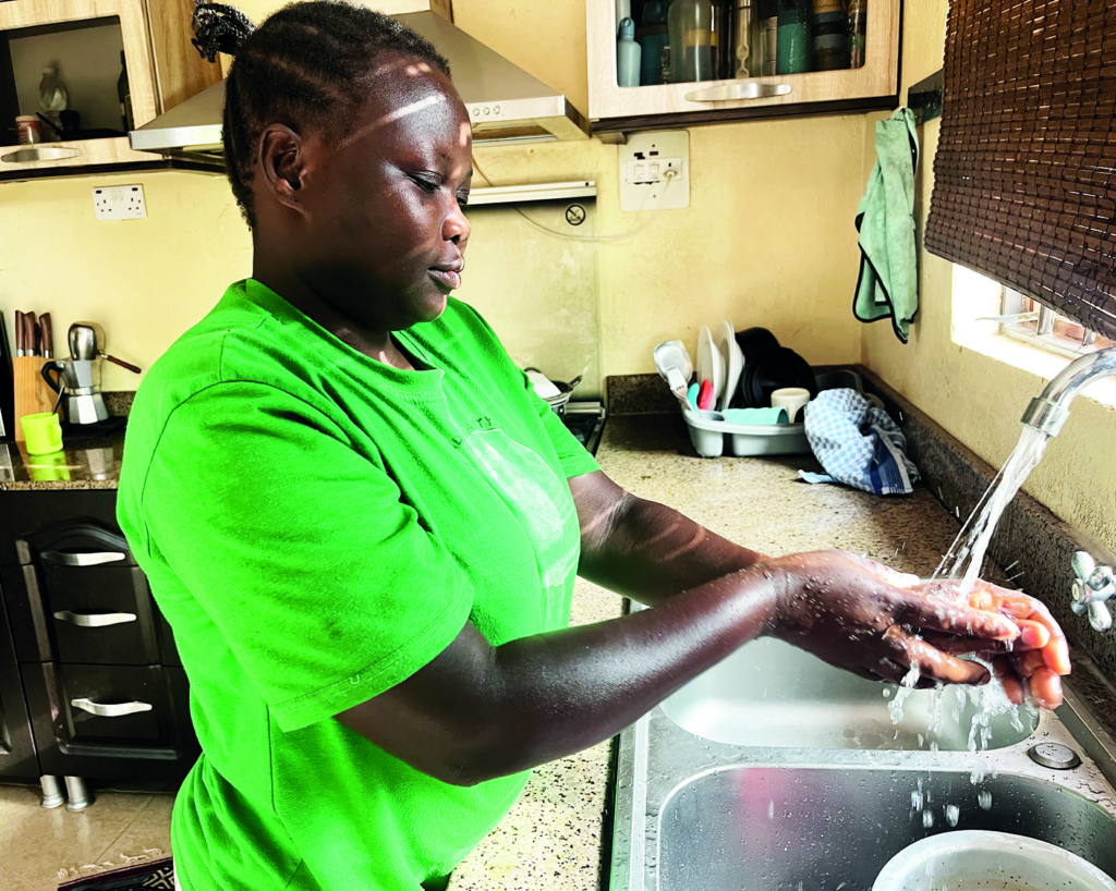 Domestic worker Medina Azikuru photographed at the home where she works. © Rodney Muhumuza for TWR